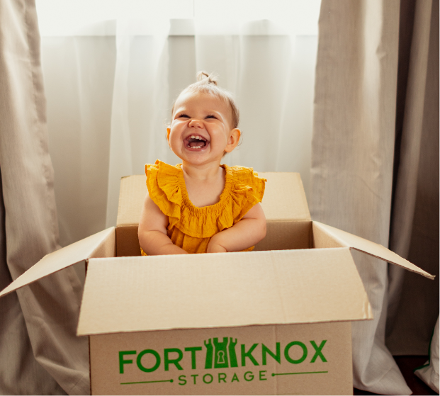 A baby inside a Fort Knox Storage box